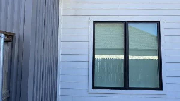 Close-up of house siding near window after soft washing by Stonevale Exterior Co. showing clean surface
