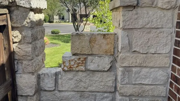 Stone alley wall after soft washing by Stonevale Exterior Co. showing clean restored natural stone