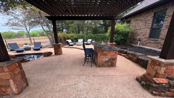 Back patio and pergola area after soft washing by Stonevale Exterior Co. showing clean stone and aggregate