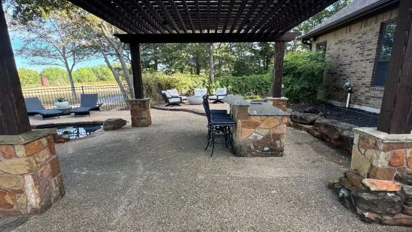Back patio and pergola area before soft washing by Stonevale Exterior Co. showing dirt buildup on aggregate