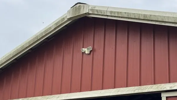 Barn gutters and fascia before soft washing by Stonevale Exterior Co. showing algae and mold buildup