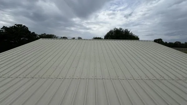Commercial barn metal roof after washing by Stonevale Exterior Co. showing clean metal panels
