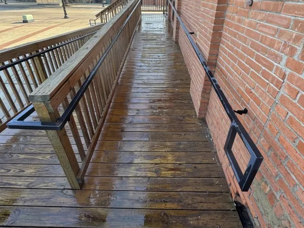 Commercial wooden deck walkway after pressure washing by Stonevale Exterior Co. in Bryan showing restored clean wood