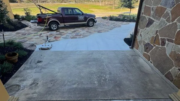 Front entry walkway before pressure washing by Stonevale Exterior Co. showing dirt and staining on concrete and stone pavers