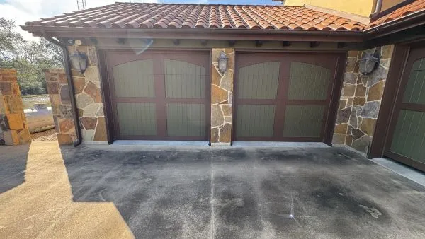 Garage driveway before pressure washing by Stonevale Exterior Co. showing dark staining