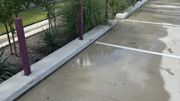 Commercial parking lot after pressure washing by Stonevale Exterior Co. showing clean curbs and fresh surface