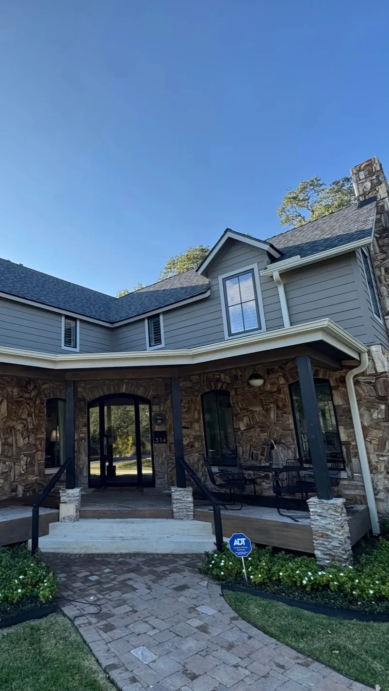 Beautiful stone and siding residential home with clean exterior in Brazos Valley after professional washing by Stonevale Exterior Co.