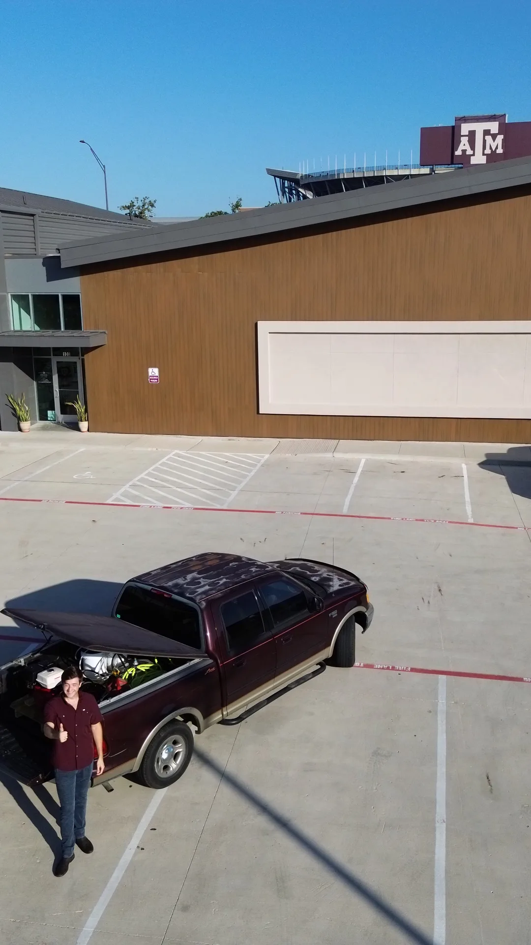 Stonevale Exterior Co. owner Garrett Miller with work truck at Aggieland Outfitters near Texas A&M campus, College Station commercial exterior cleaning